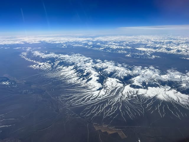 Snow capped ranges spreading across the Pacific Northwest, Idaho and Montana